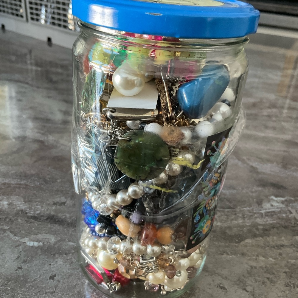 Glass Jar Filled with Assorted Jewelry